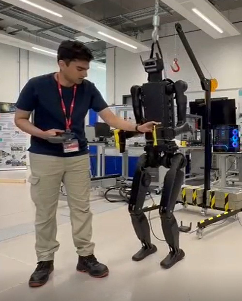 Rakshith Bangalore with the Unitree H1-2 humanoid robot on its gantry